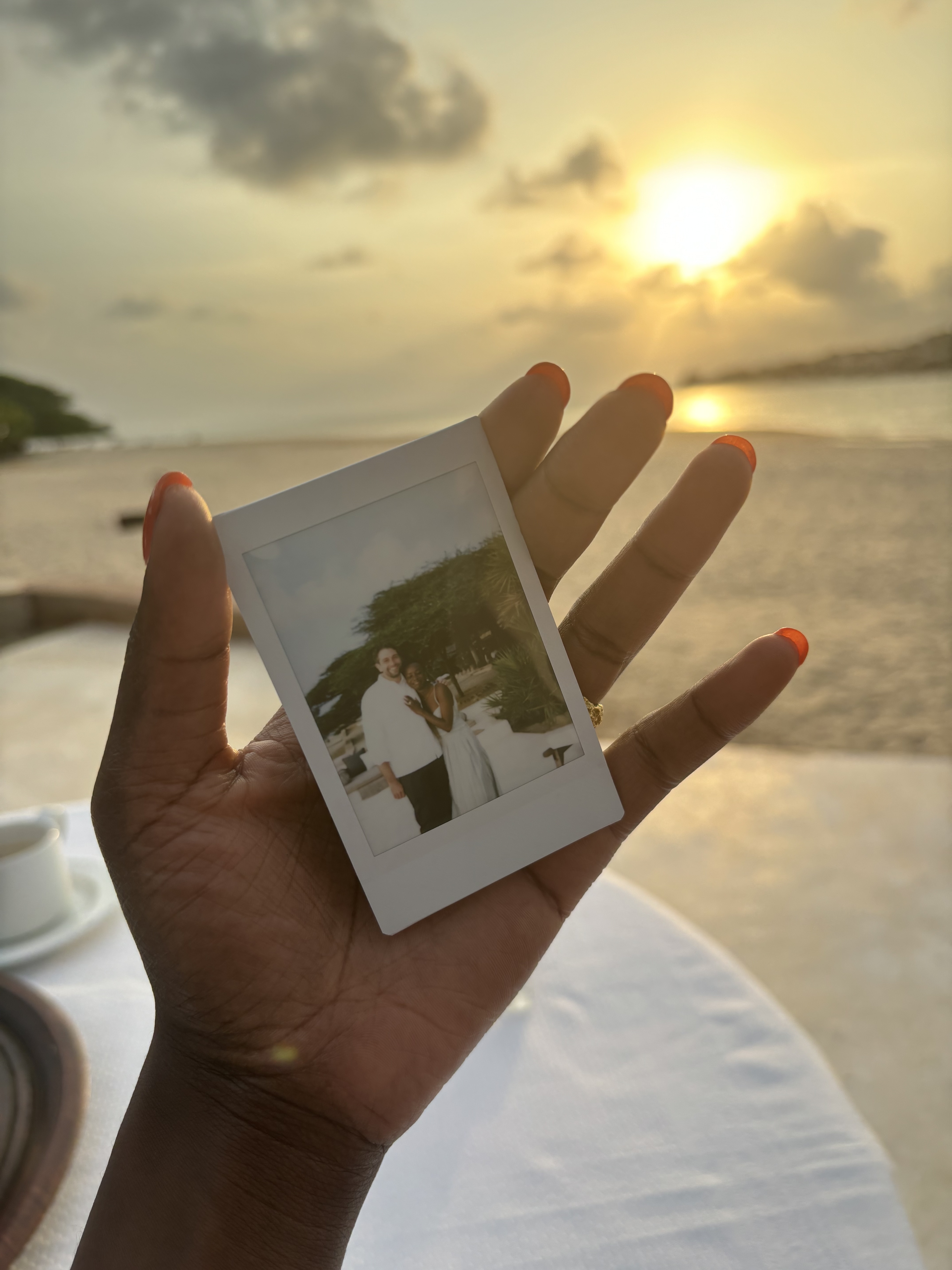zisiga holding polaroid photo that strangers took of us by the beach when we got engaged
